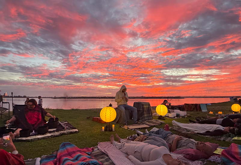 Sunset Soundbath gathering by the water